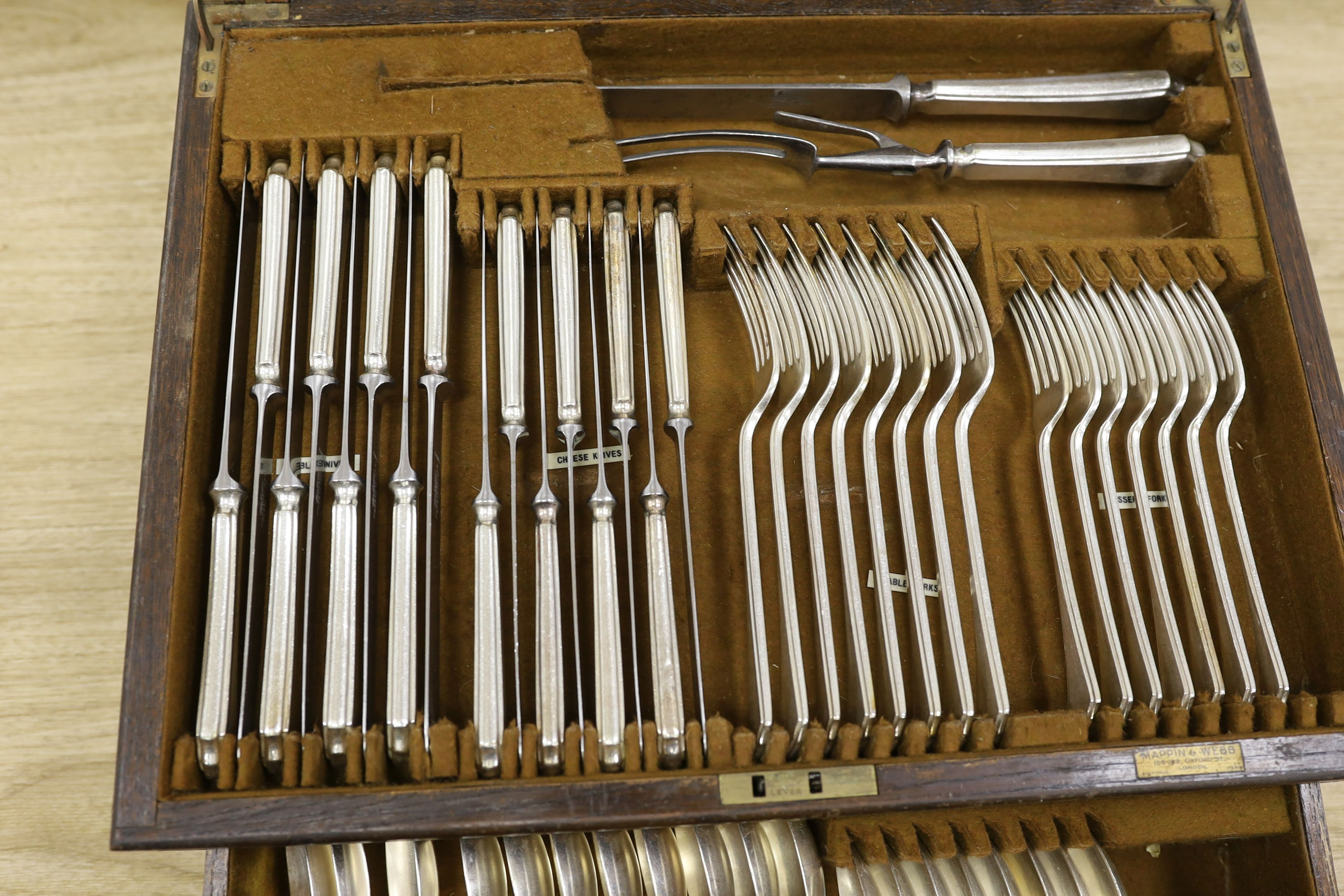 A pair of plated telescopic candlesticks and a Mappin & Webb part canteen of plated cutlery